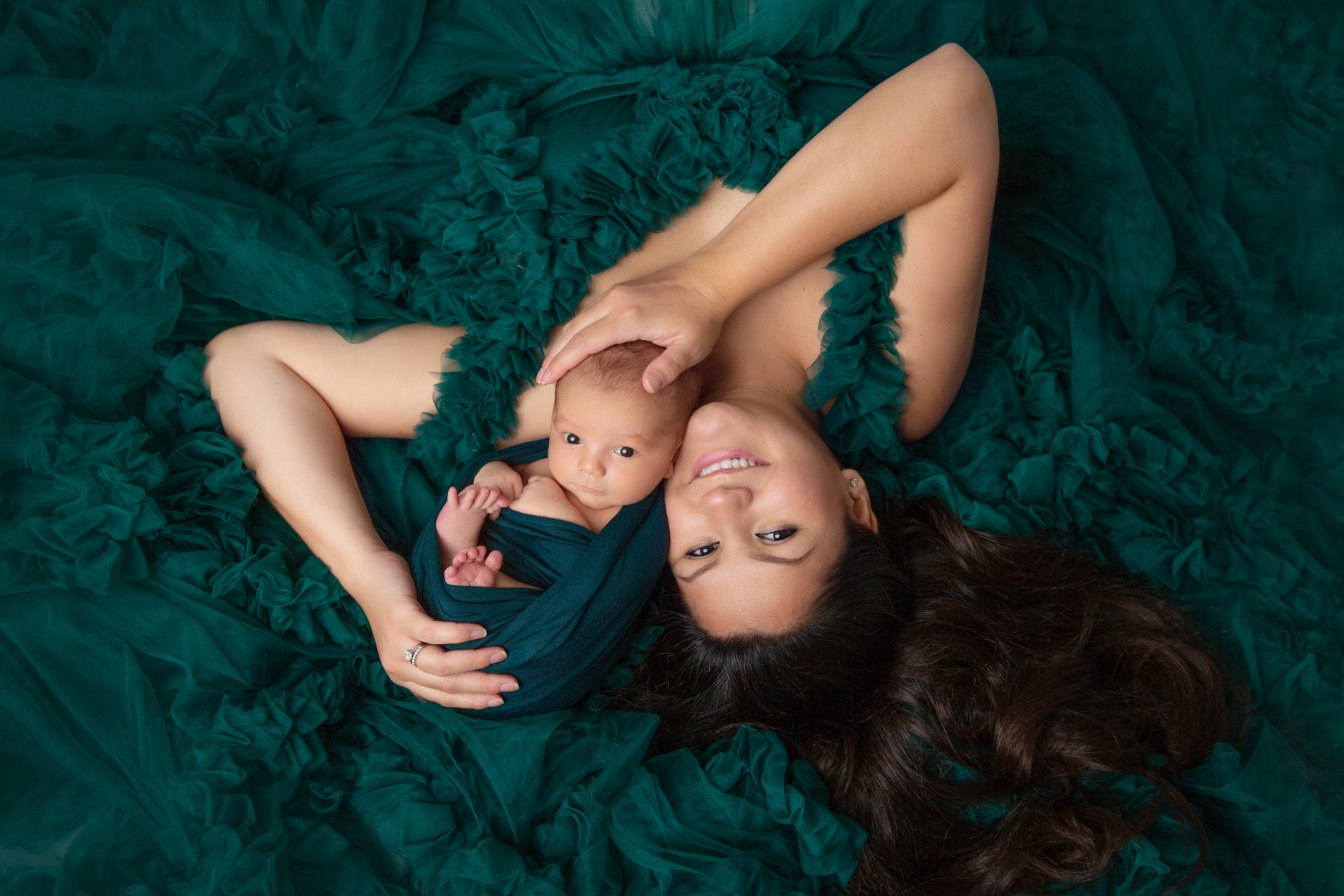 new jersey newborn & family photographer Sofia Ribeiro, captures a baby boy with mom in a green gown.