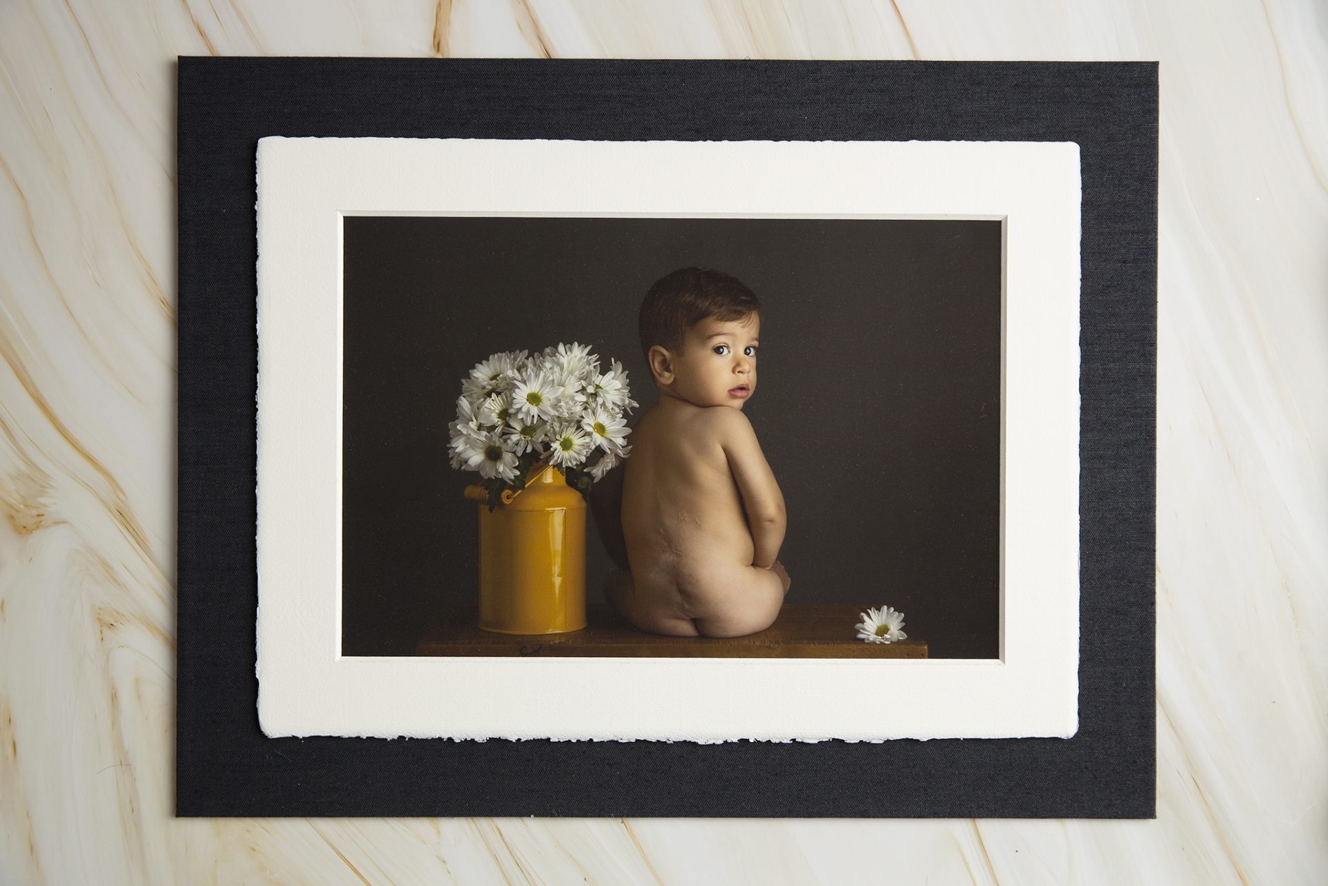 little boy sits and looks back at the camera during a session with a new jersey childrens photographer