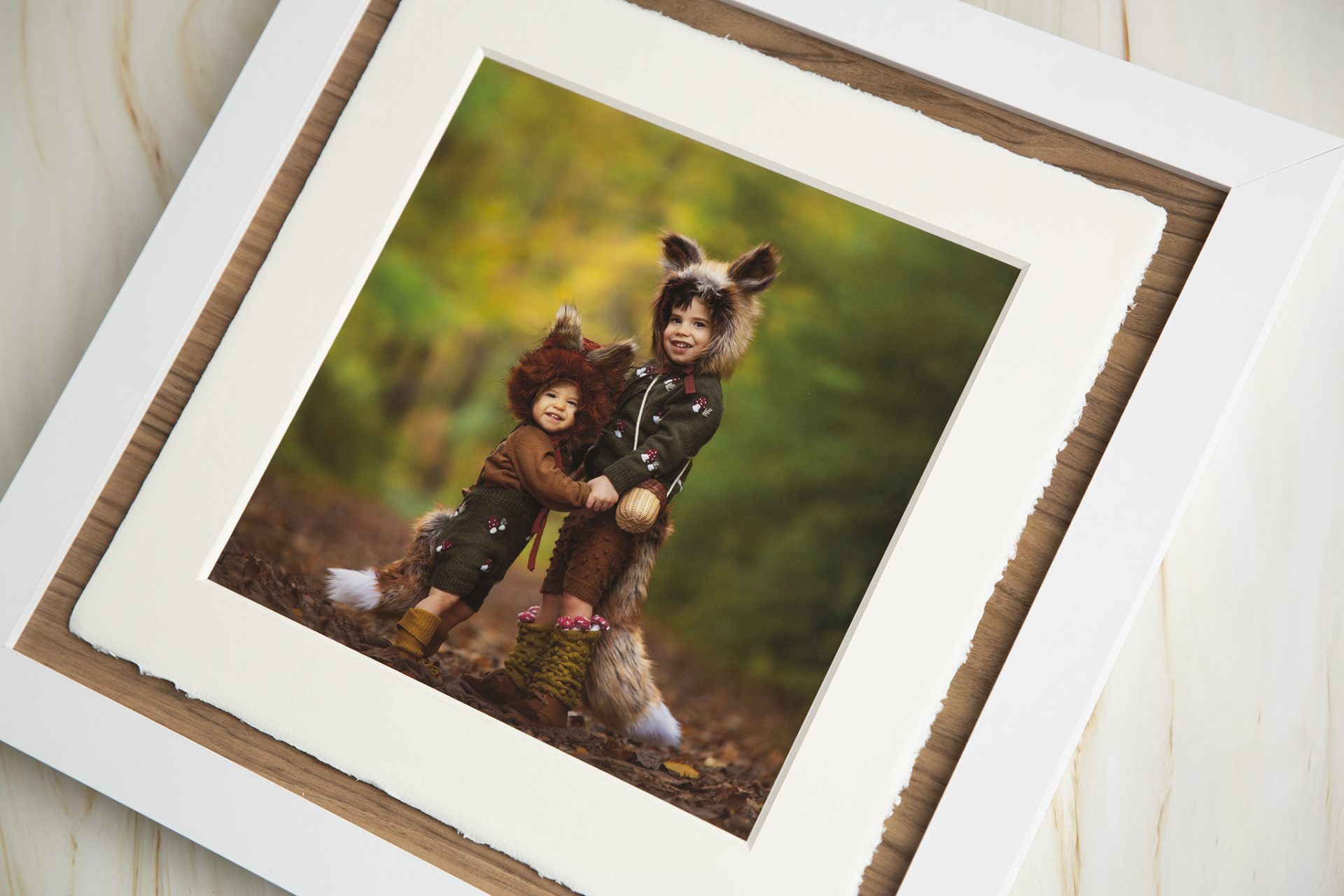 children dressed as foxes play together in the woods during a session with a new jersey children's phtoographer
