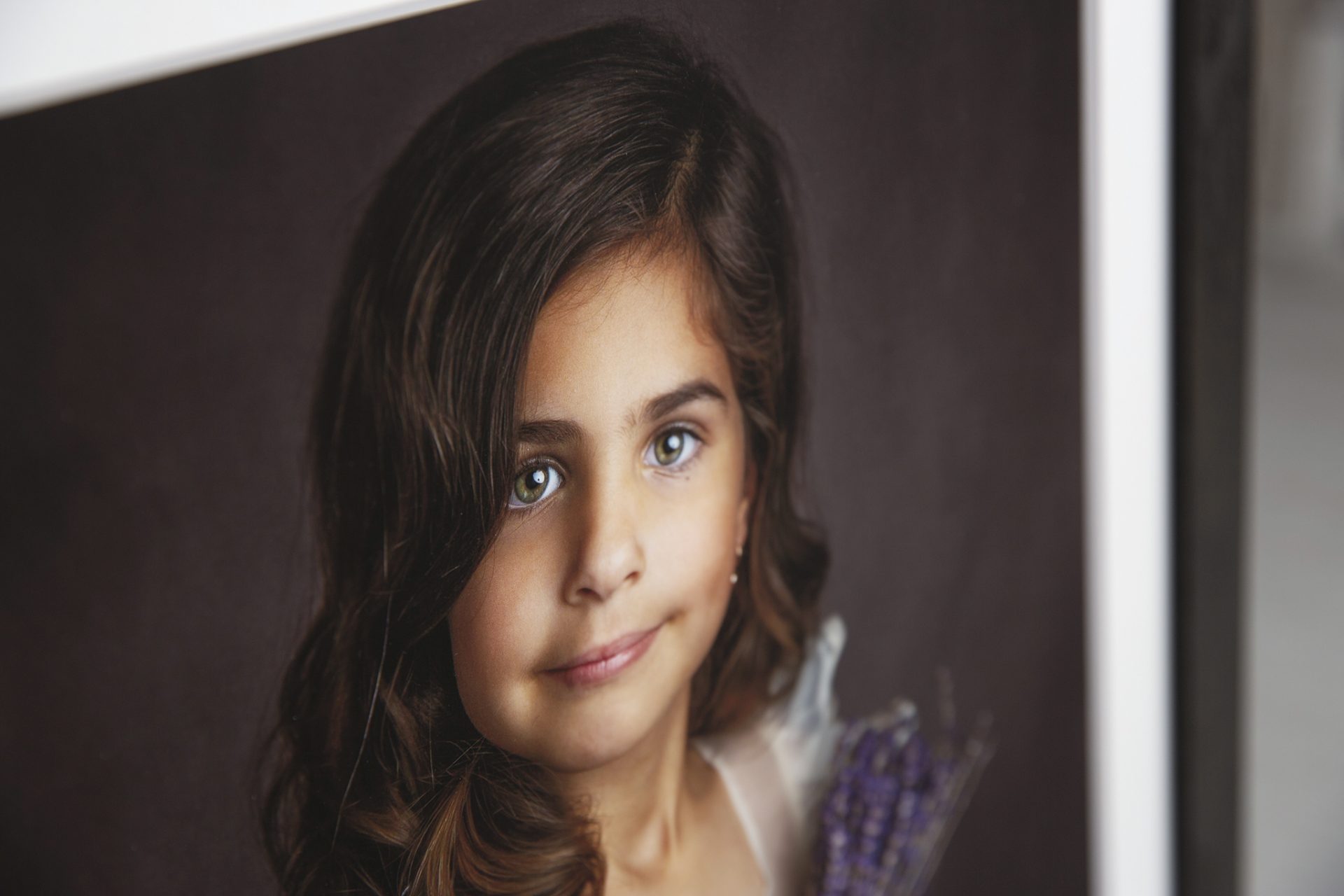 little girl holds a bouquet of lavender during a portrait session in a nj photography studio