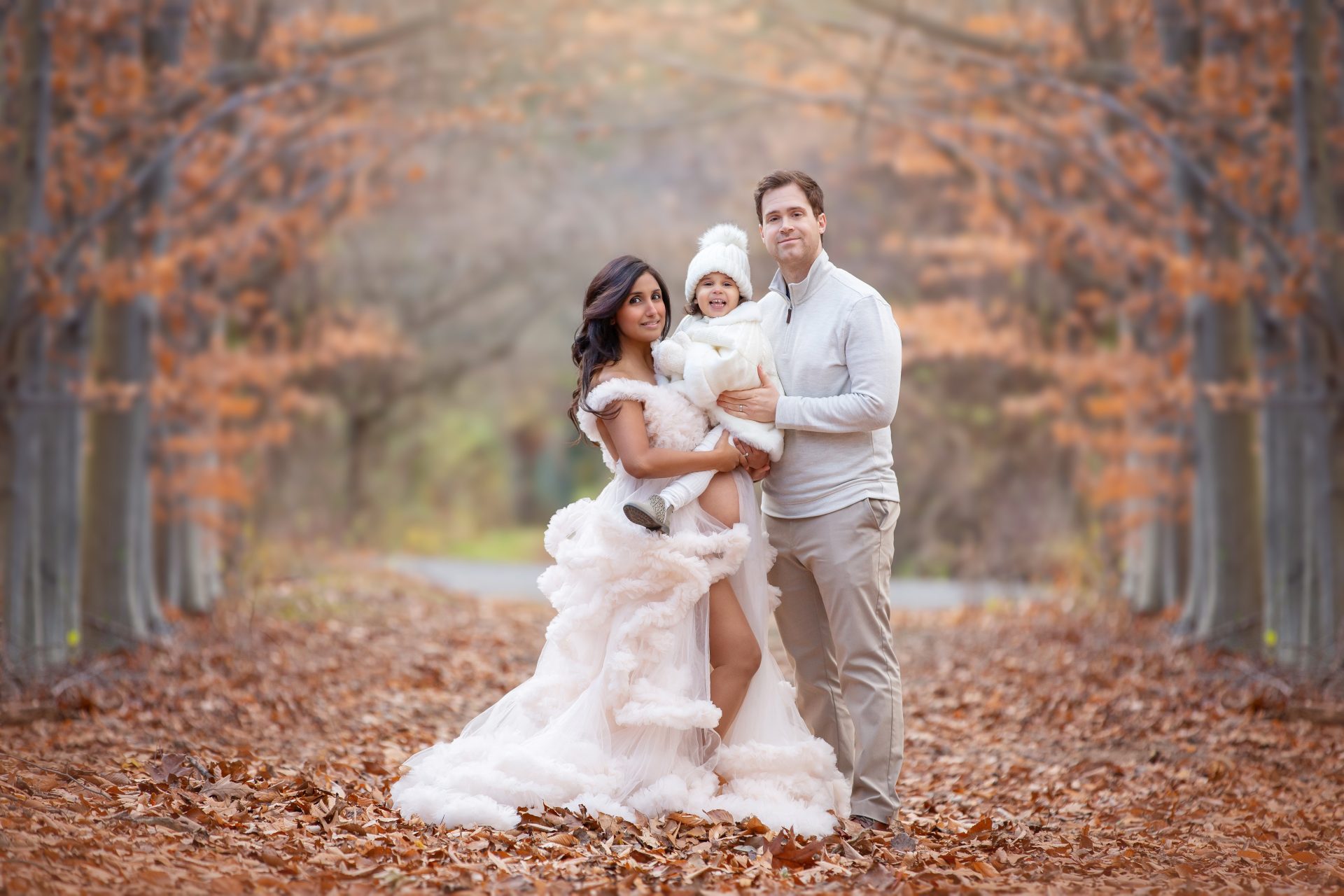 reasons to take maternity photos, mom with family in white dress in winter in a local park in New Jersey