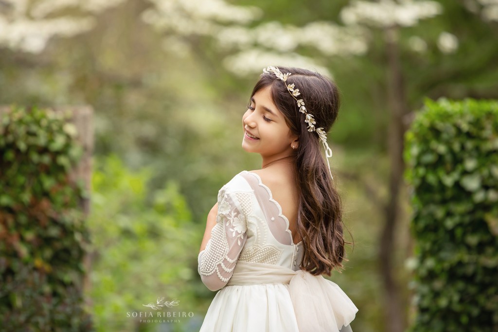 A GRACEFUL SOFT IMAGE OF A GIRL IN HER COMMUNION GOWN