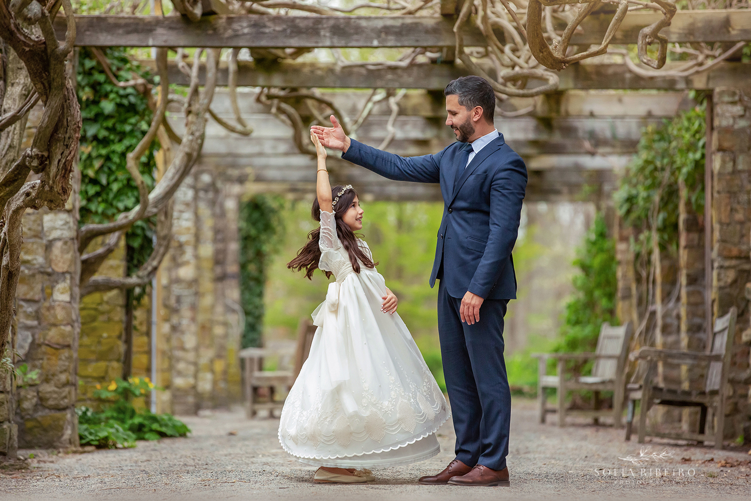 DAD TWIRLS HIS LITTLE GIRL IN HER COMMUNION DRESS