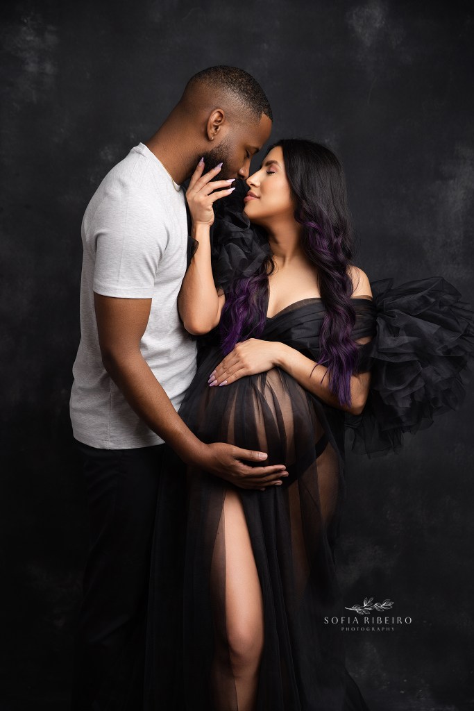 mom and dad pose together with tulle dress highlighting belly with an nj maternity photographer
