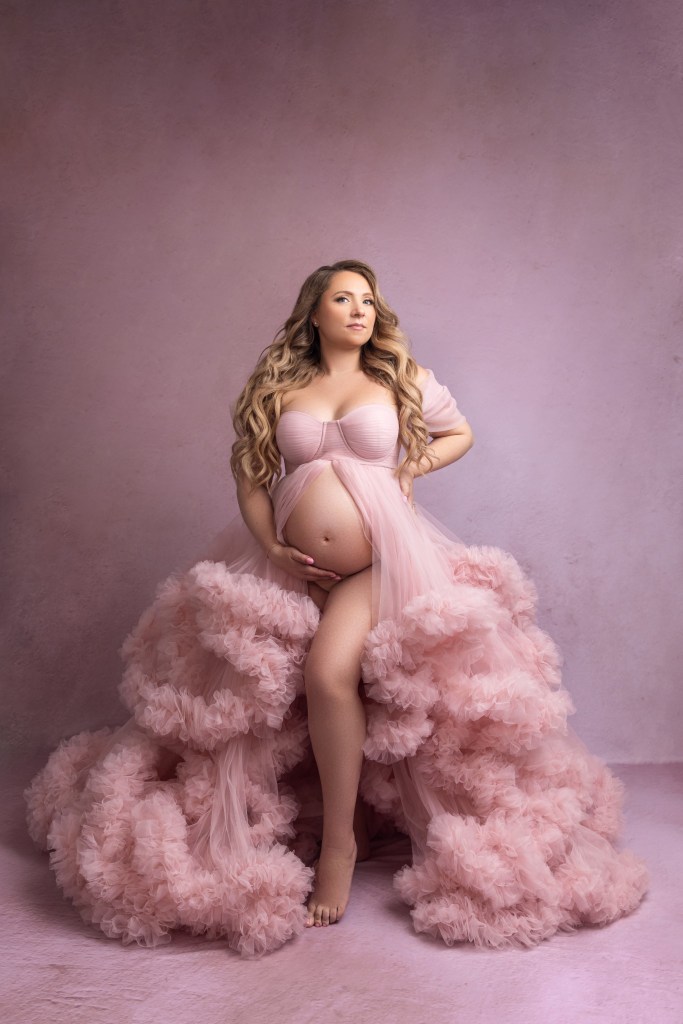 mom in pink ruffly maternity gown
