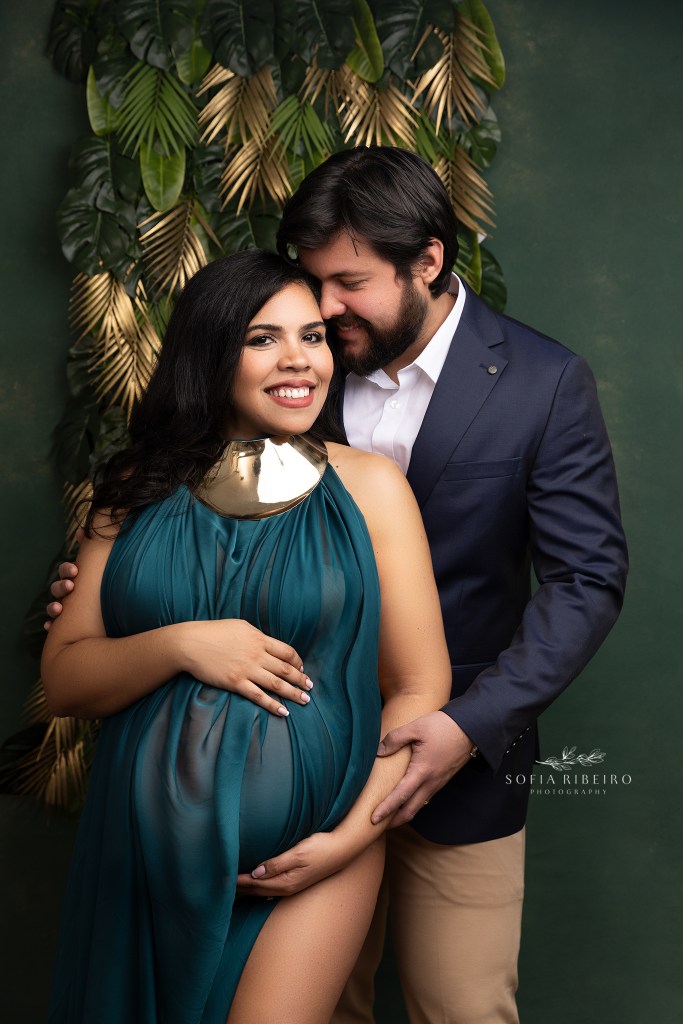 mom and husband pose in a brazilian inspired setup for their maternity portraits with west new york maternity photographer
