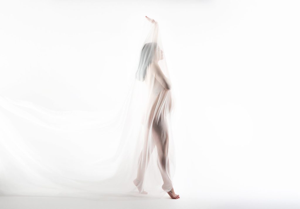 reasons to take maternity photos, mom solo draped in white fabric, backlit