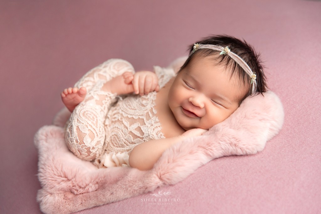hudson county newborn photographer, baby girl in pink smiling