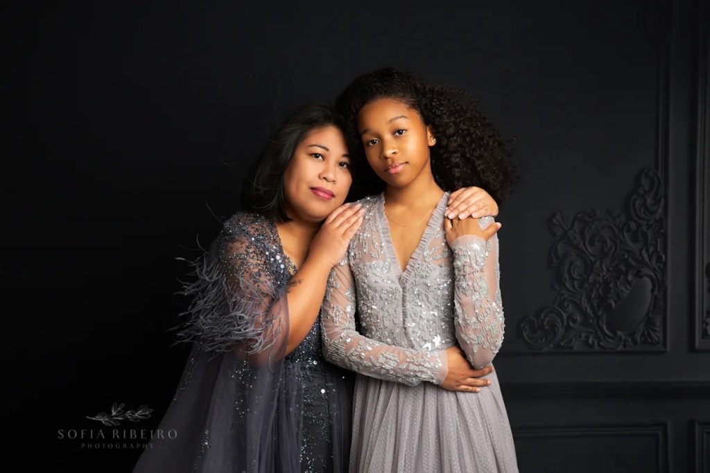 mom and daughter pose together in shades of grey dresses for mother's day photos in nj