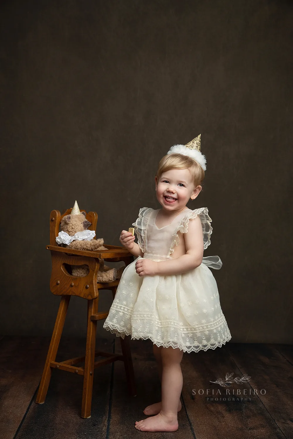 LITTLE GIRL WITH TEDDY AND BIRTHDAY HAT CELEBRATES HER SECOND BIRTHDAY AFTER TAKING PHOTOS WITH NJ CHILDRENS PHOTOGRAPHER IN STUDIO
