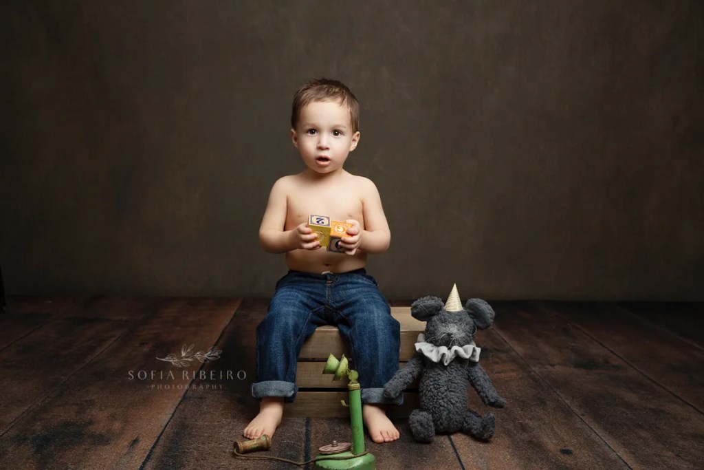 LITTLE BOY PLAYS WITH A VINTAGE PHONE DURING A BIRTHDAY SESSION WITH A NJ CHILDREN'S PHOTOGRAPHER