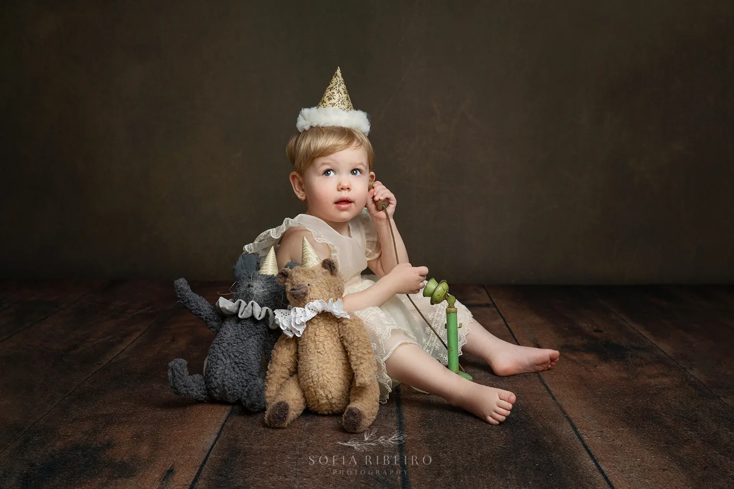 LITTLE GIRL WITH TEDDY AND BIRTHDAY HAT CELEBRATES HER SECOND BIRTHDAY AFTER TAKING PHOTOS WITH NJ CHILDRENS PHOTOGRAPHER IN STUDIO