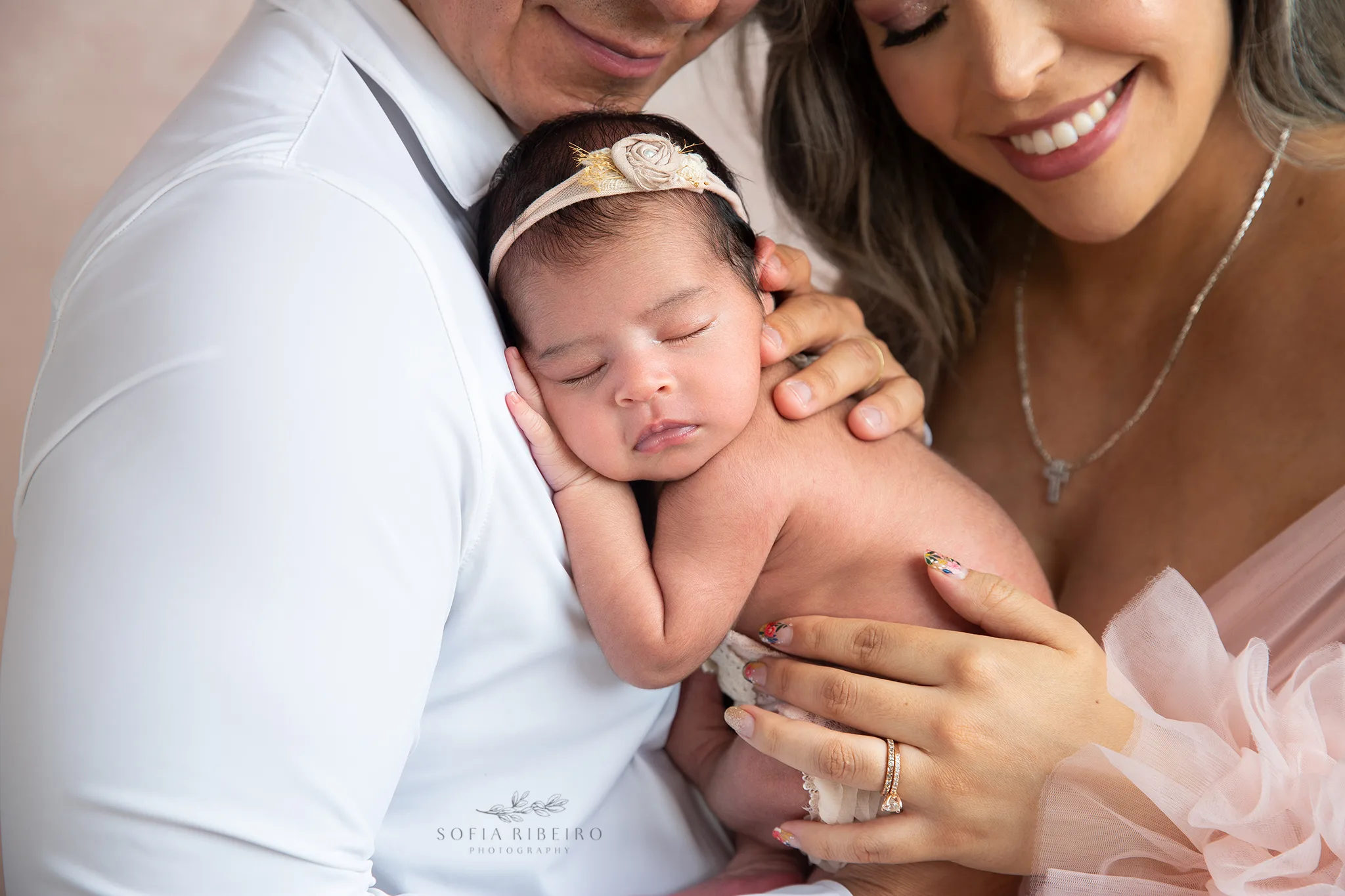 a closeup of a newborn baby girl in her parents hands during a photo session in new jersey