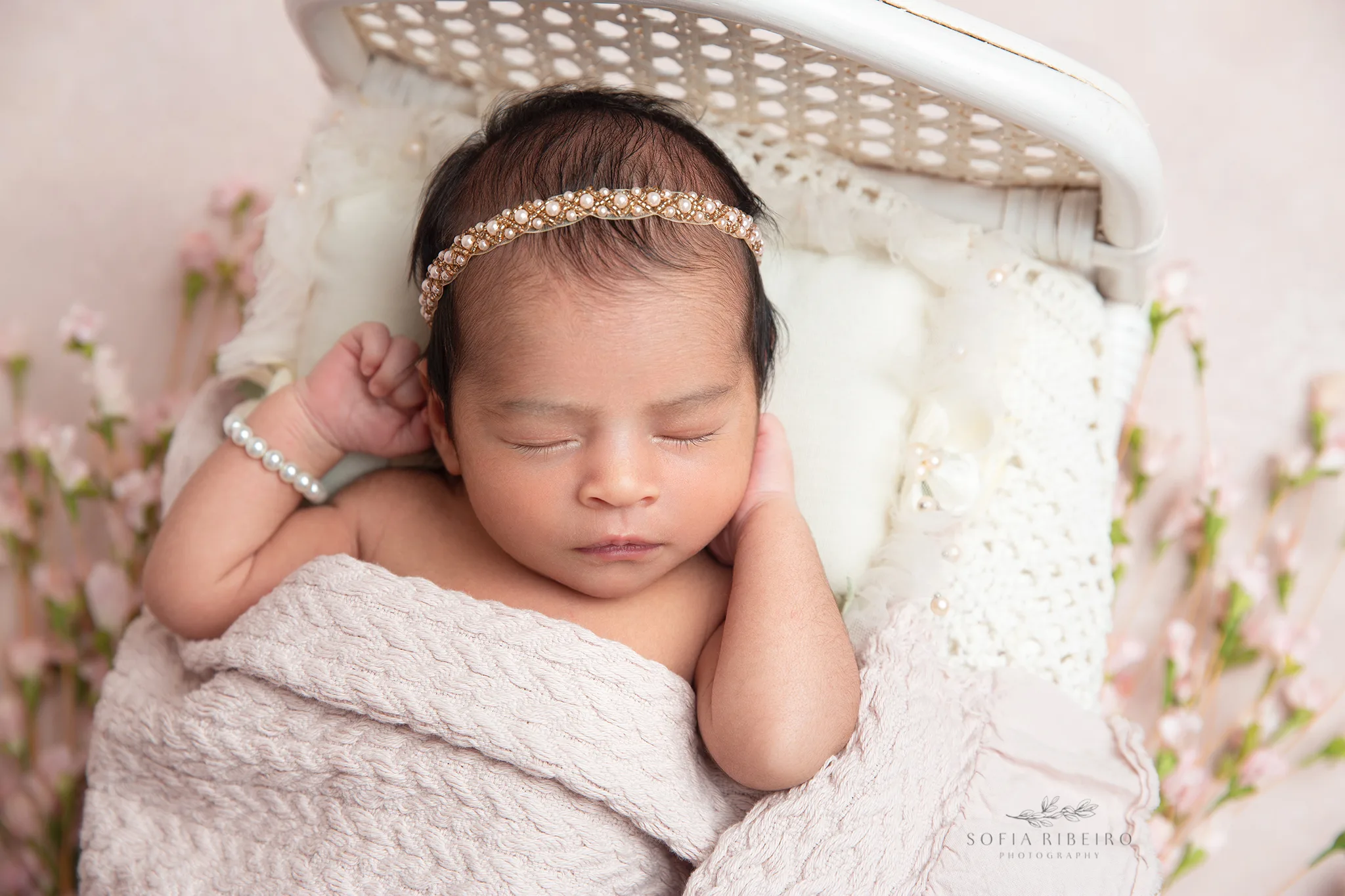 newborn baby girl is posed in a bed prop by a nj baby photographer
