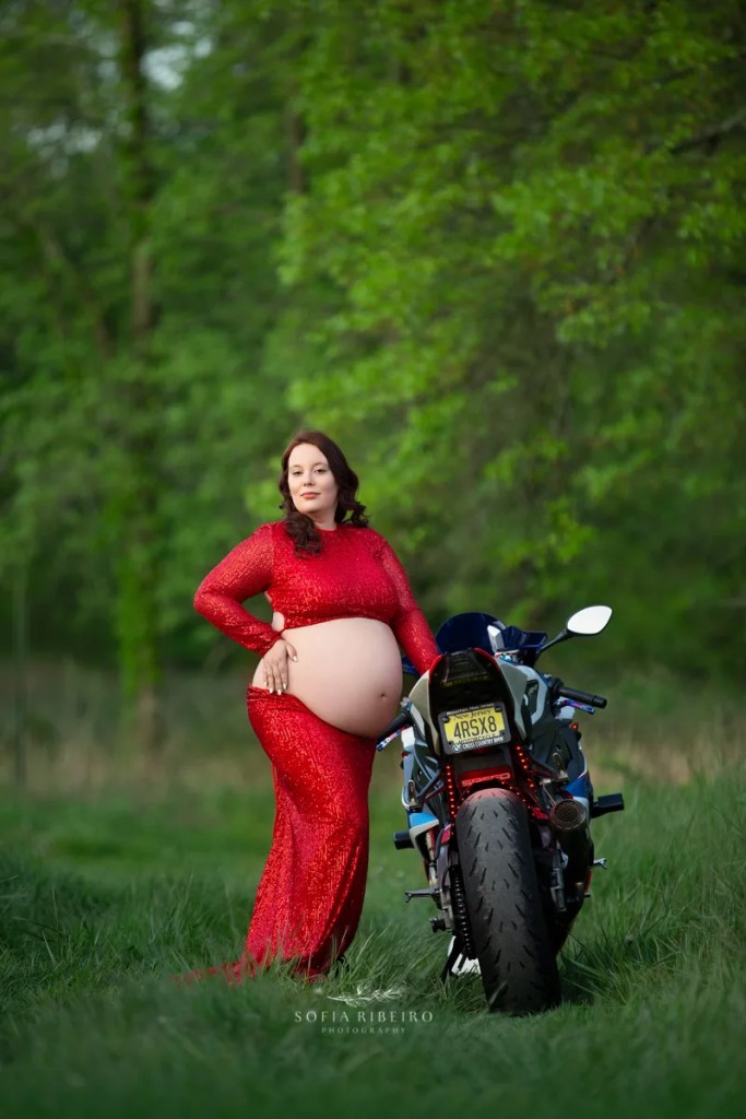 motorcycle maternity session outdoors with red and blue motorcycle