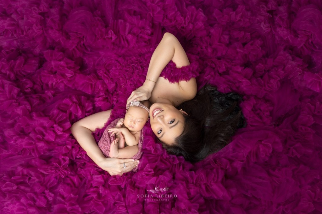 edgewater nj newborn photographer, mom and baby wrapped in pink ruffles