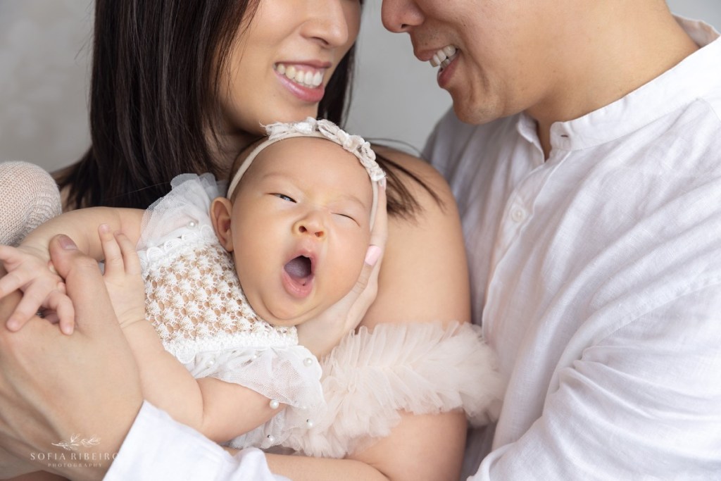 edgewater nj newborn photographer, parents with baby yawning, closeup