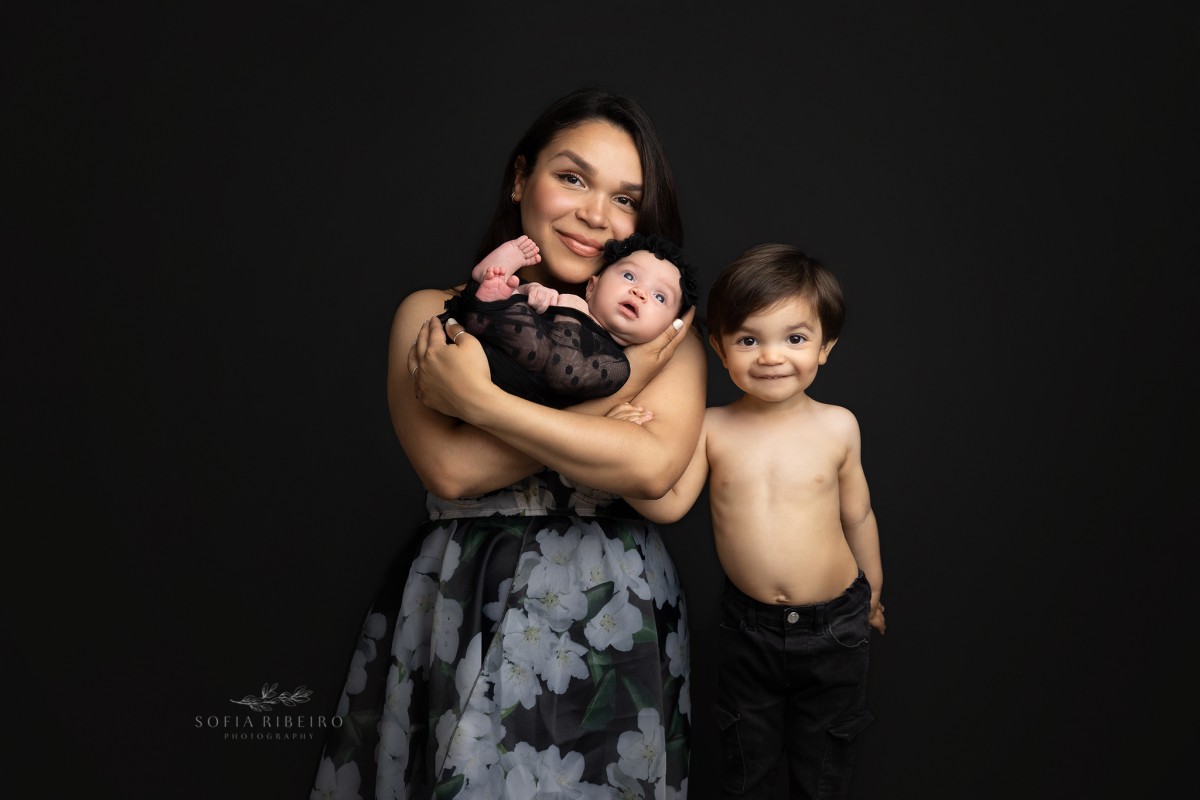 mom, baby, and older brother in black newborn session, sparta nj newborn photographer