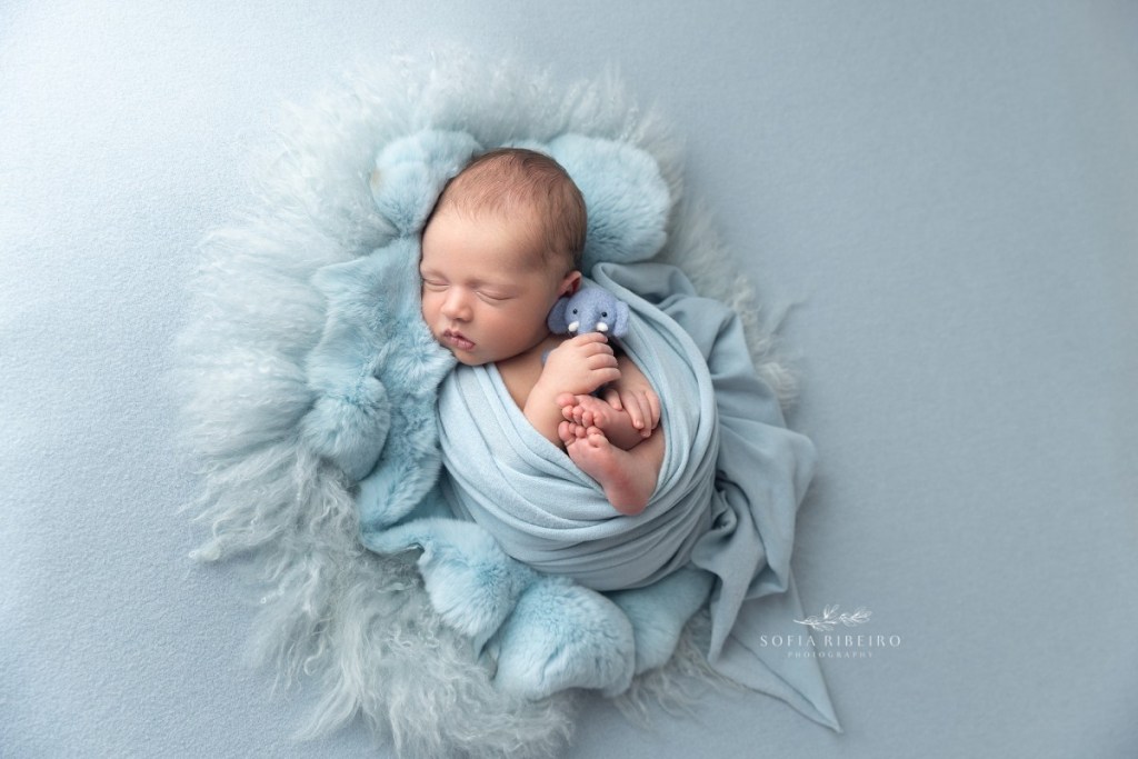 north bergen nj newborn photographer, baby in light blue wrap on blue fur texture