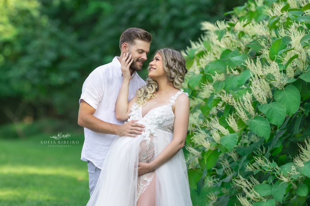 outdoor maternity photography nj, mom in a white gown looking into dad's face