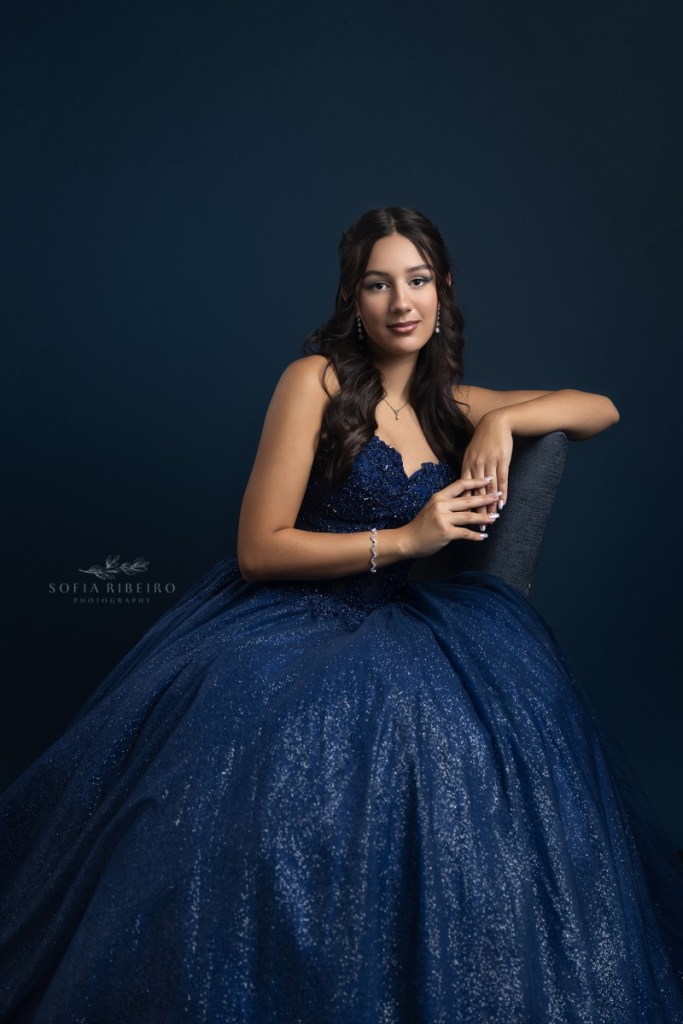 teen celebrates her sweet sixteen in a navy blue gown after taking portraits with a new jersey childrens photographer