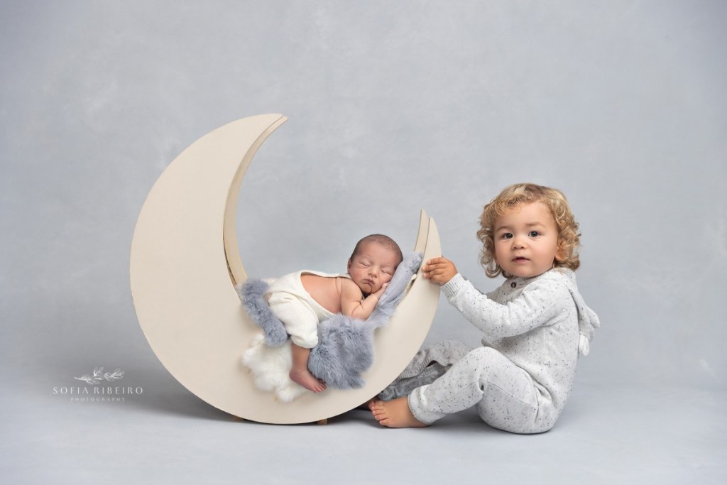 grey newborn session, baby on moon with big brother