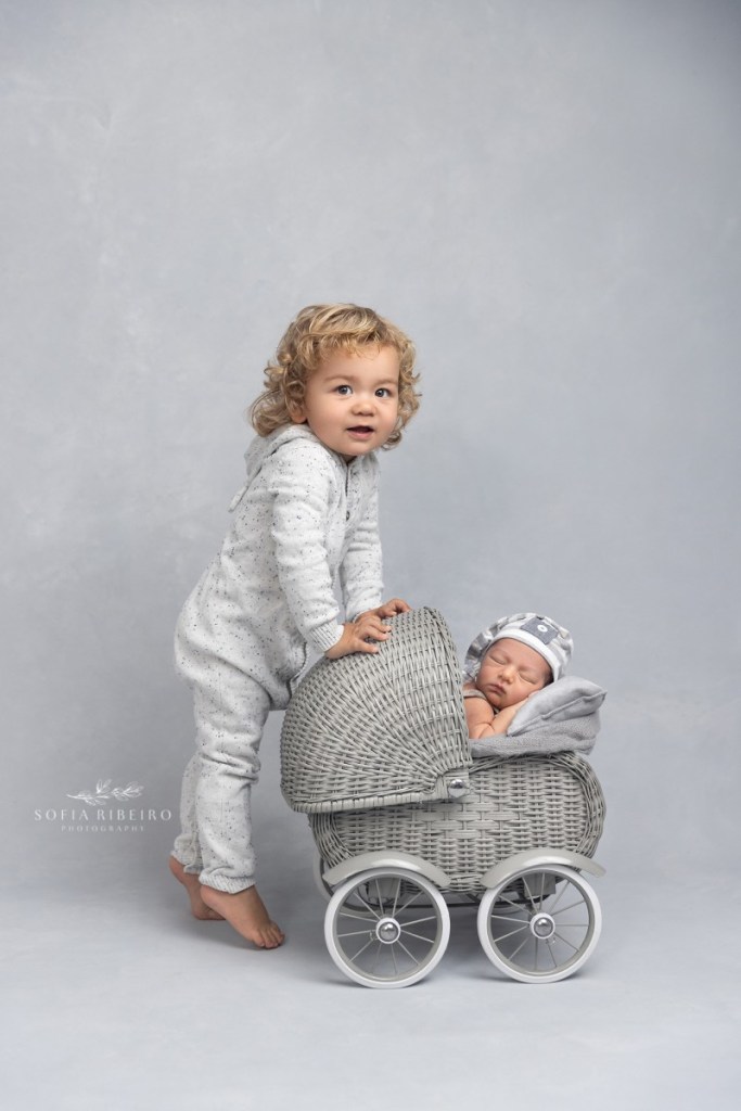 grey newborn session, baby in pram with big brother