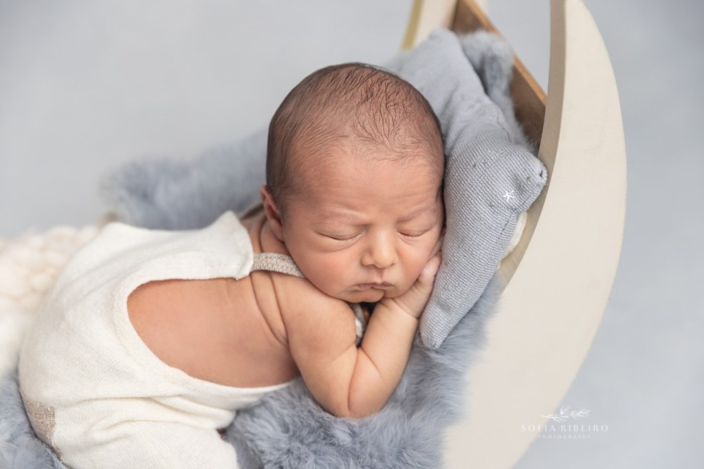 grey newborn session, baby in moon prop in cream outfit