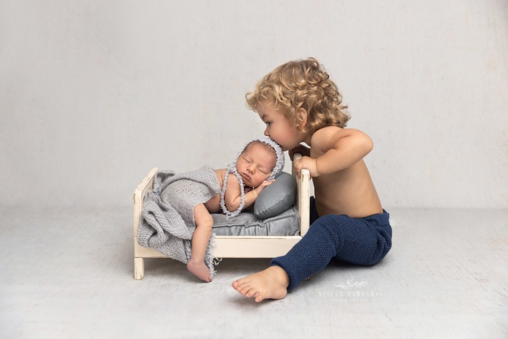 grey newborn session, baby in bed with big brother