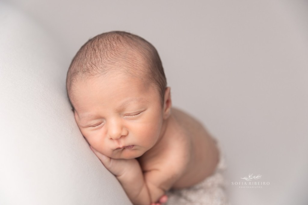 neutral beige baby newborn session with baby curled up