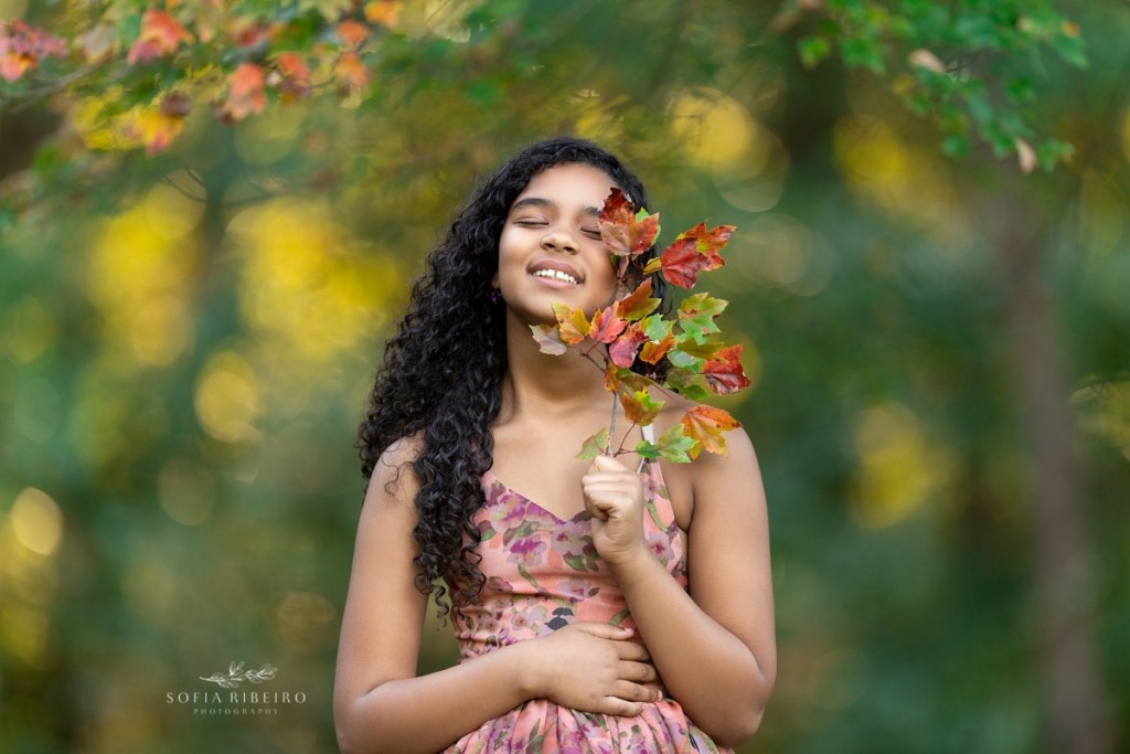 family photo session at watchung reservation, nj, daughter with leaves and gown