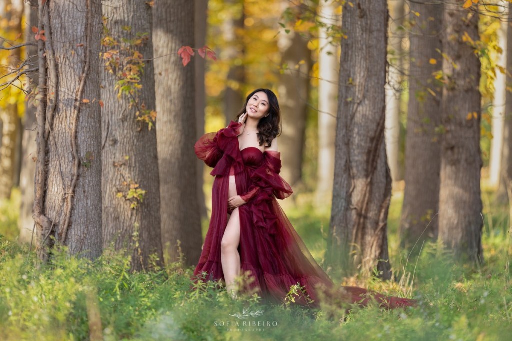 maternity session with mom in red dress in a local park in new jersey in the fall