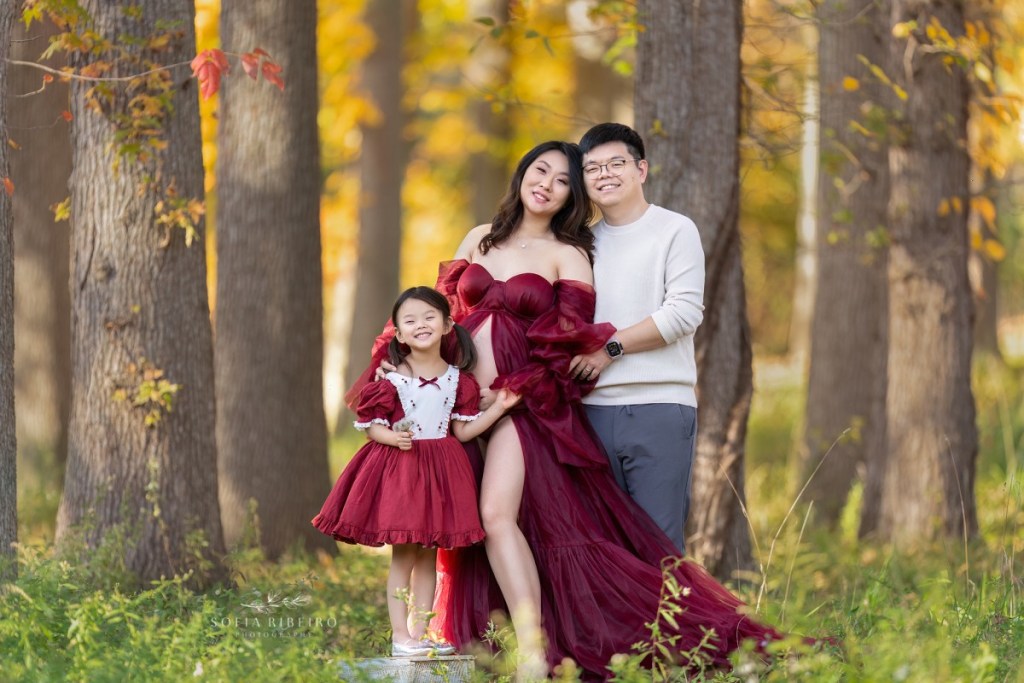maternity session with mom and family in a red dress in a local park in new jersey in the fall