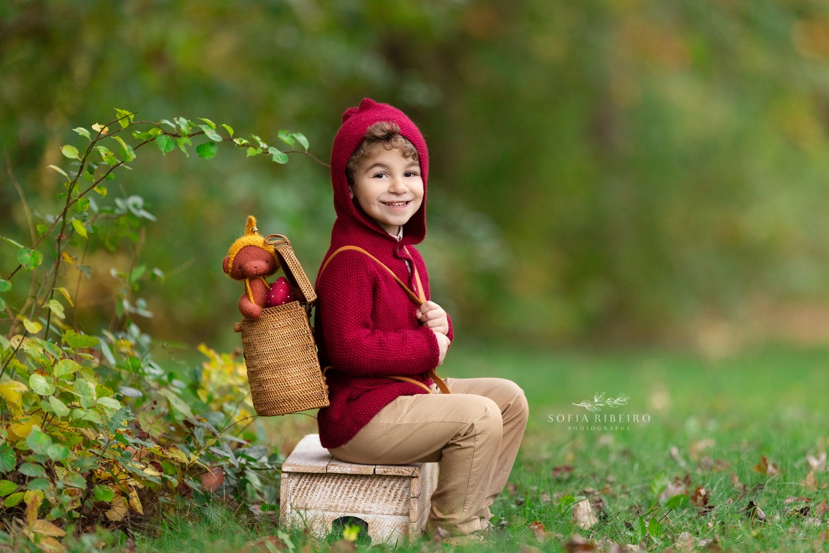 little boy poses with a teddy bear during a childrens photo session in nj