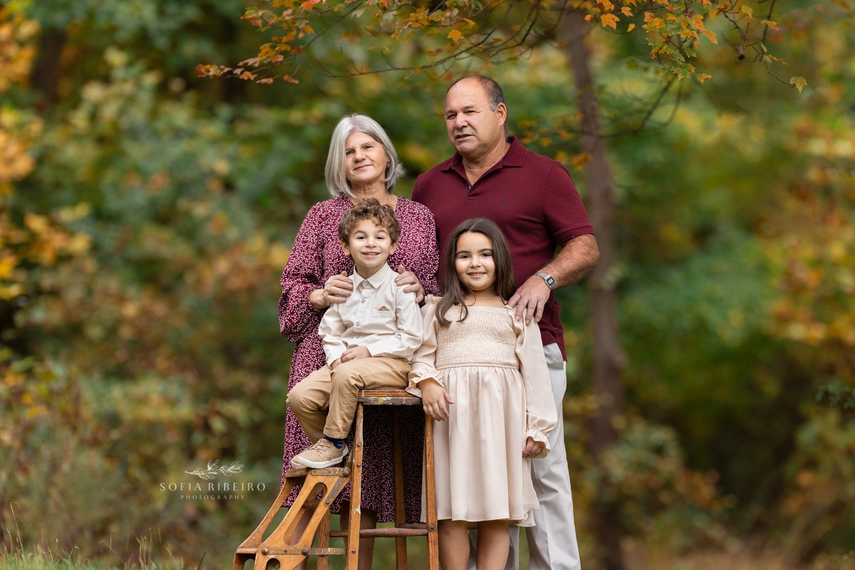grandparents pose together with grandchildren in the grass
