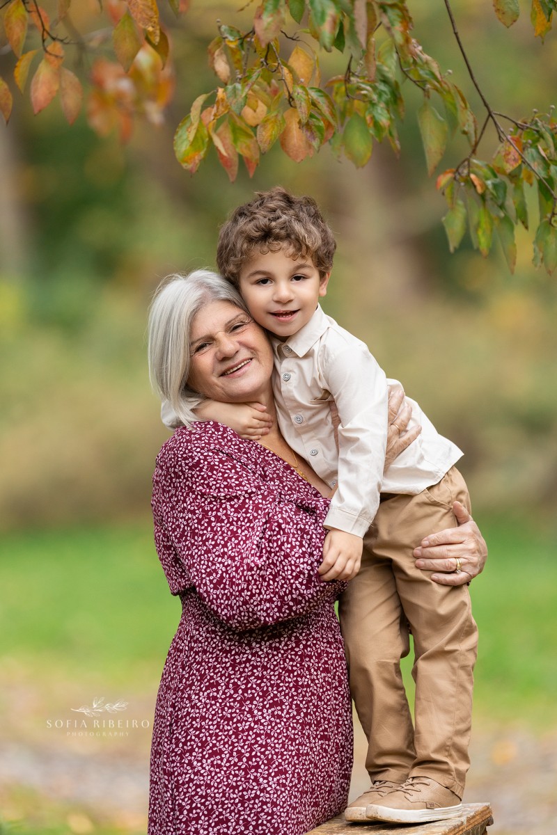 grandmother poses with grandson during a family session