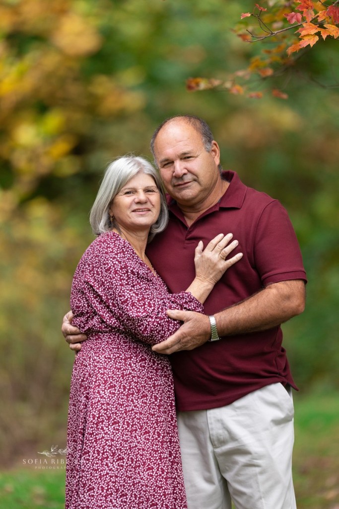 grandparents pose together before a grandparent and grandchildren session