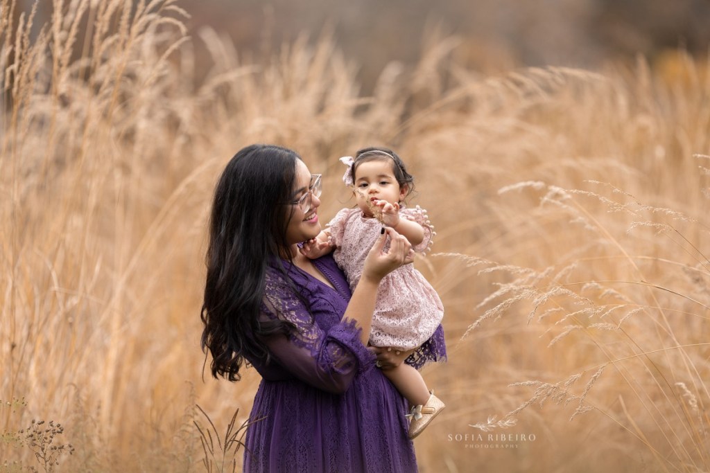 mom and baby in a field of hay during a fall family session in nj