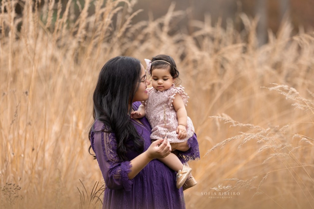 mom and baby in a field of hay during a fall family session in nj