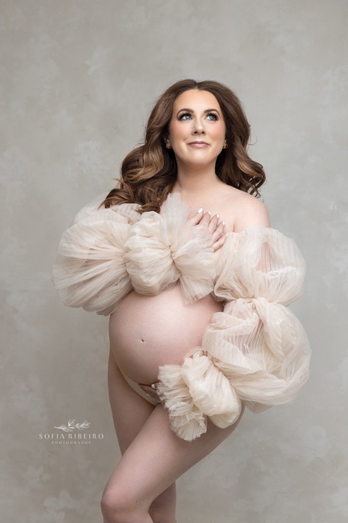 pregnant mom poses in a tulle sleeves during a session with a south plainfield nj maternity photographer