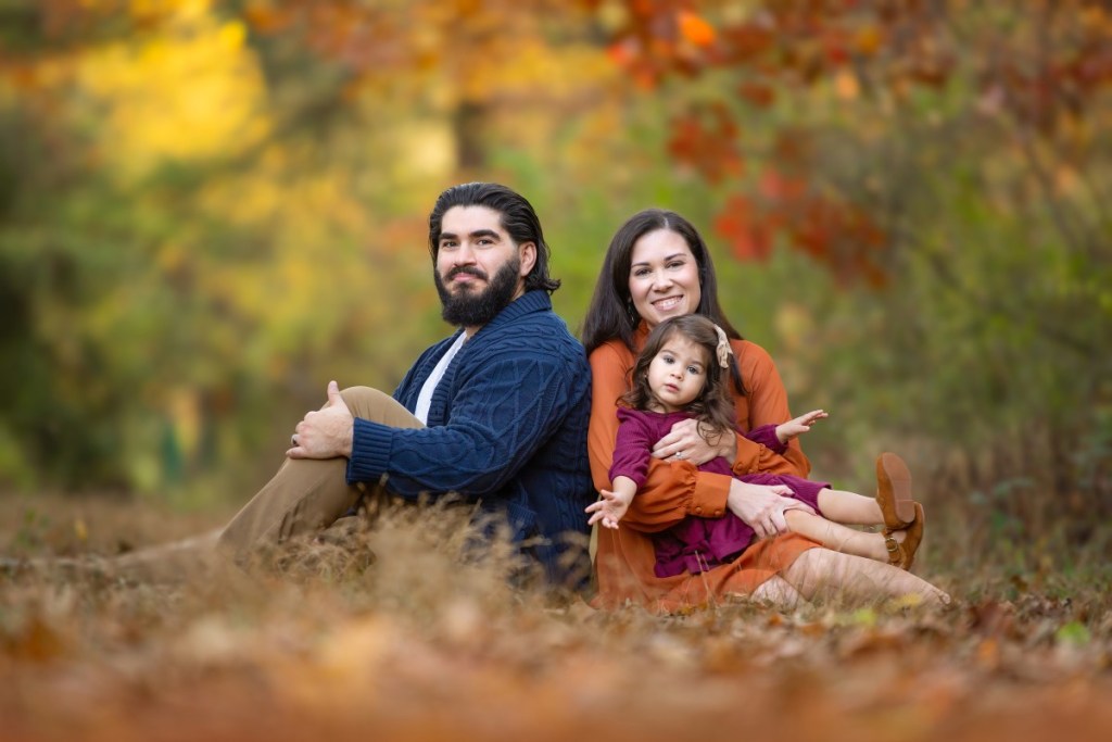 family takes a fall photo outdoors together before heading to a parent and me class in nj