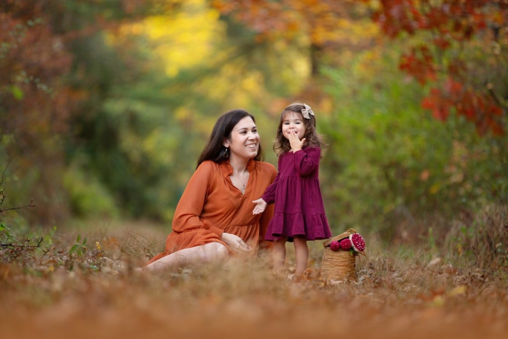 mom and baby play together outdoors in the fall before heading to a mommy and me class in nj