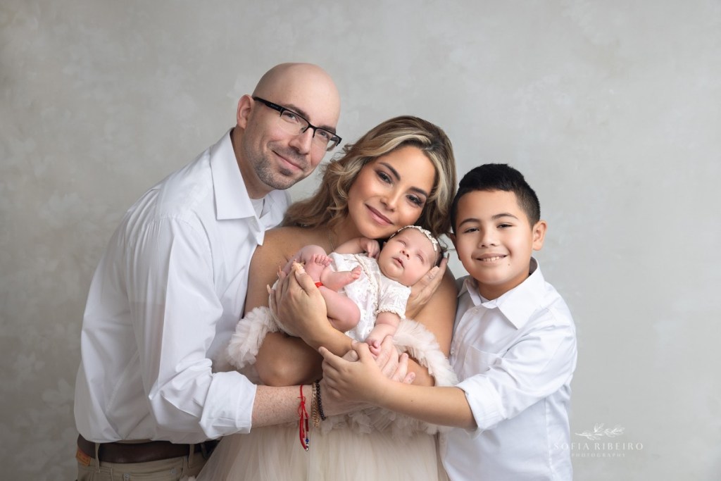 mom dad and baby snuggle together during a nj newborn photography session