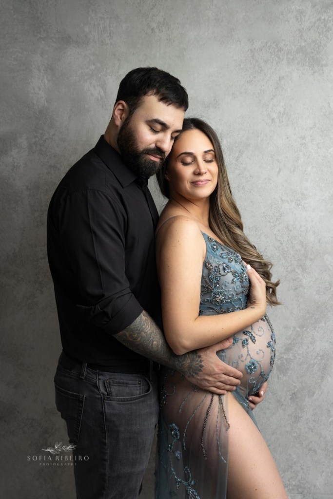 mom and dad share a loving embrace during a maternity session in nj