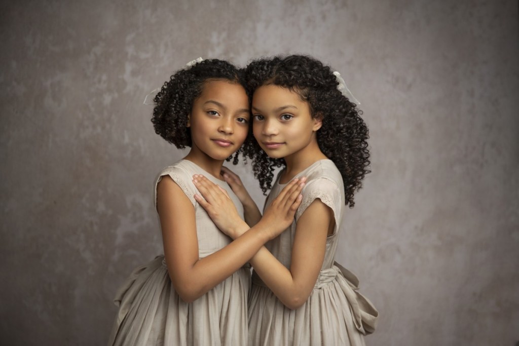 two sisters embrace during a photo session with a nj childrens photographer