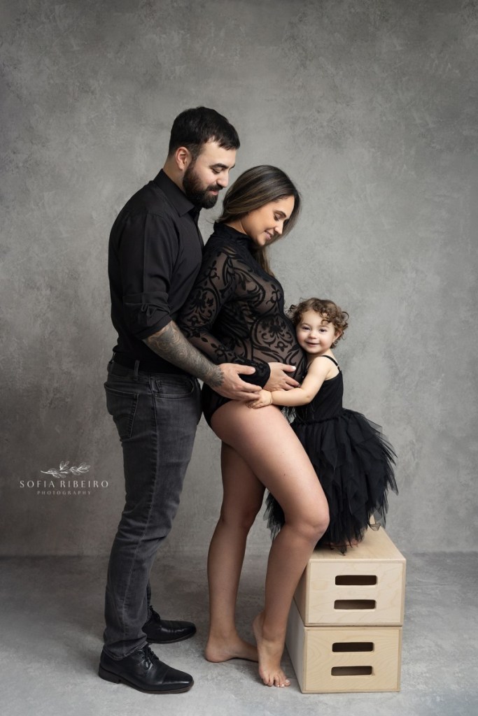 baby hugs mom's belly during a maternity session with an nj photographer