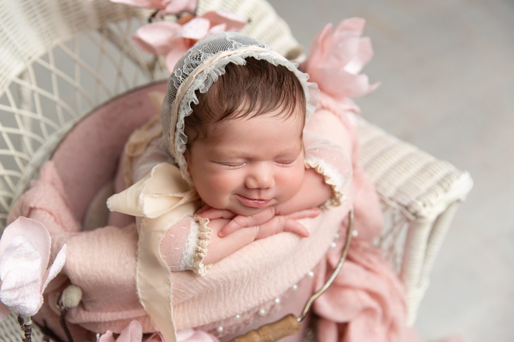 smiling baby girl during a newborn session with a nj newborn photographer