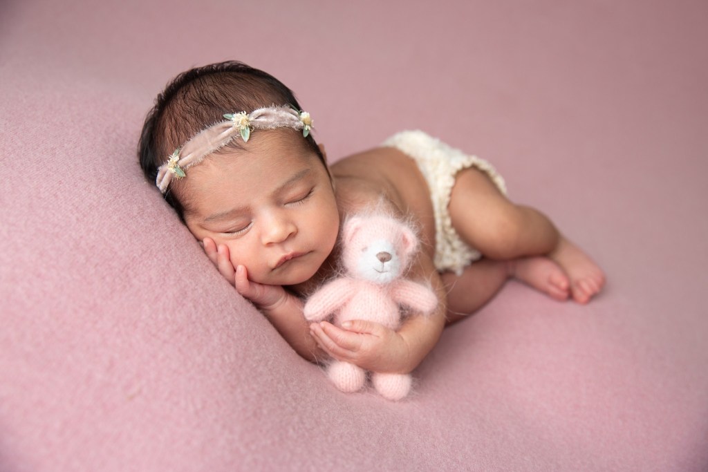 baby girl poses with teddy bear during a newborn session with a nj newborn photographer