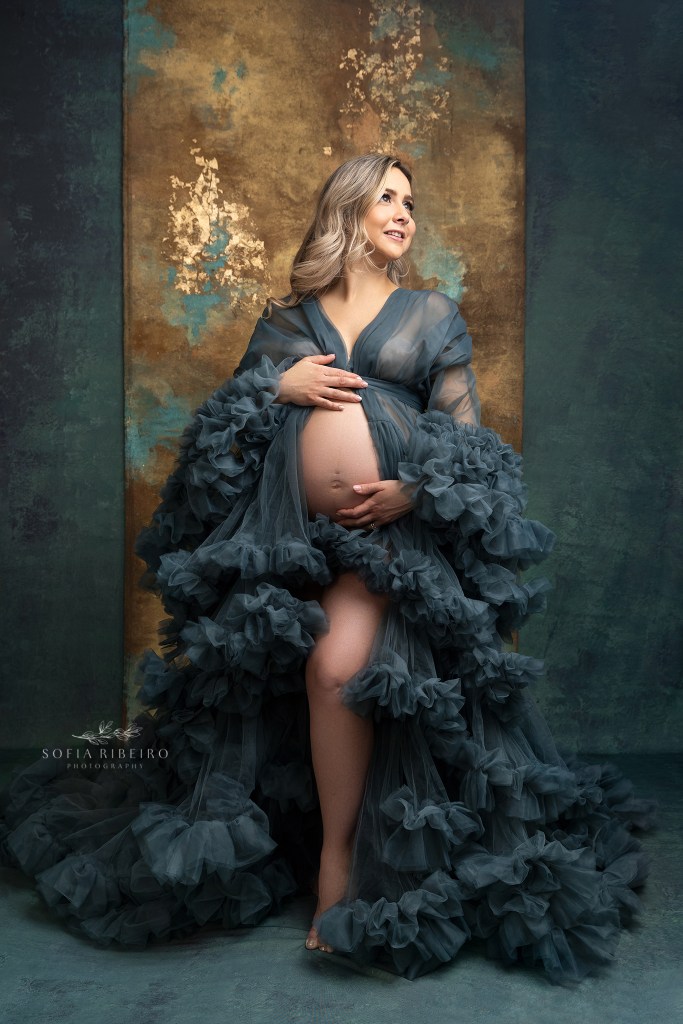 mom poses in a teal ruffled robe exposing her belly during a photo session with a clark nj maternity photographer