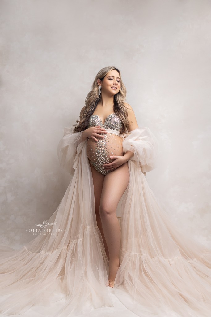 mom poses in a rhinestone bodysuit and robe during a maternity session in clark nj